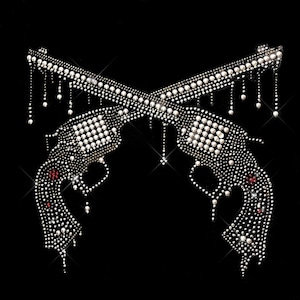 May include: Two silver pistols crossed over each other, made of rhinestones on a black background.
