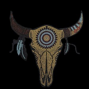 May include: A gold and black rhinestone bull skull with a beaded design and feathers. The skull has a circular design in the center with a black, white, and blue pattern.
