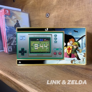 Proudly display your Game & Watch Zelda edition in your game room, garage or bedroom. Each shelf arrives with 3M Velcro Command Strips, instructions.