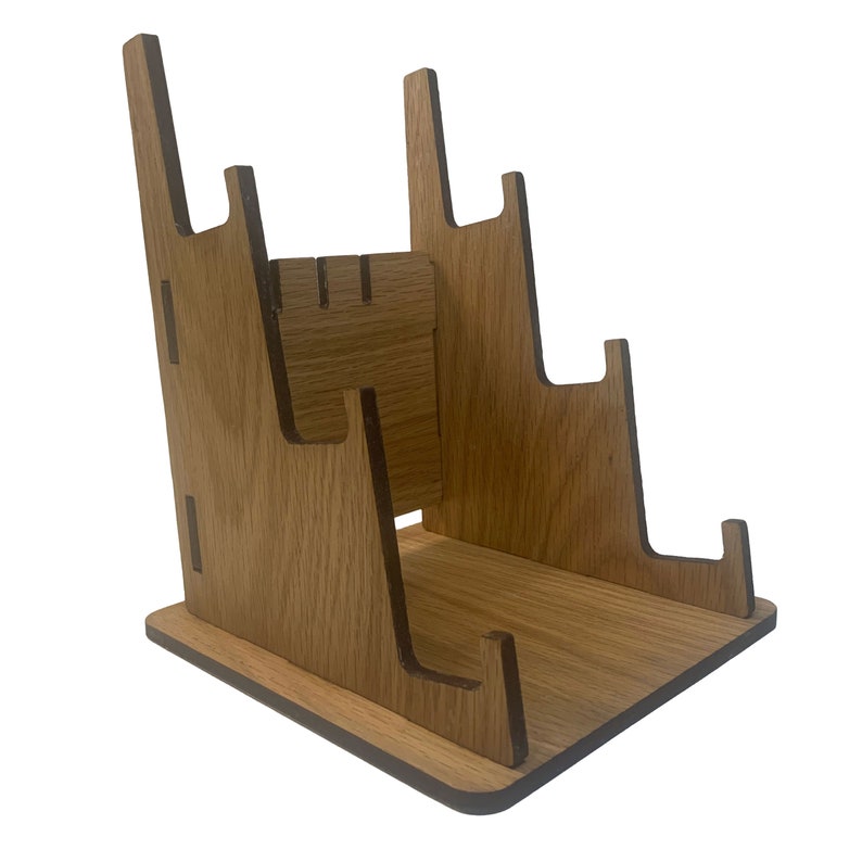 May include: A wooden stand with multiple slots for holding records. The stand is made of light brown wood and has a natural finish.