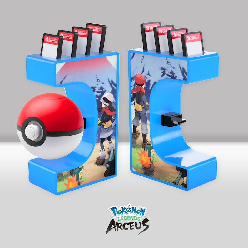May include: A blue and white Nintendo Switch game stand with a Pok&eacute; Ball and a Pok&eacute;mon Legends: Arceus logo. The stand has a slot for a game cartridge and a USB-C port.
