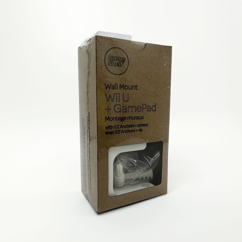 May include: A brown cardboard box with a white label that says "Game Shelf" in a circle. The label also says "Wall Mount Wii U + GamePad Montage muraux with EZ Anchors + screws avec EZ Anchors + vis". The box contains a white plastic wall mount for a video game controller.