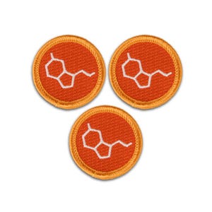 May include: Three circular embroidered patches featuring a vibrant orange background with a white chemical structure design. Each patch has a stitched border in a matching orange thread, creating a uniform set of round textile emblems.