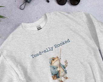 Sudadera divertida con ranas pescando, camiseta con juego de palabras "Toad-ally Hooked" y top con gráfico de rana estilo cottagecore.