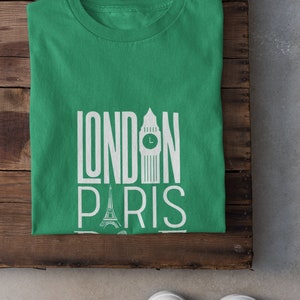 May include: A green t-shirt with the words "LONDON PARIS" printed in white. The graphic includes an illustration of Big Ben and the Eiffel Tower.