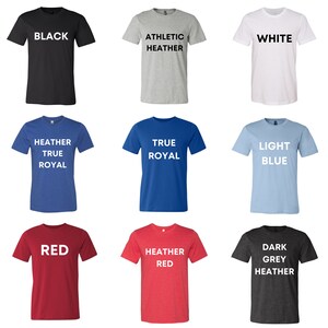 May include: A grid of nine t-shirts in various colors, each with a different color name printed in white. Colors include black, athletic heather, white, heather true royal, true royal, light blue, red, heather red, and dark grey heather.