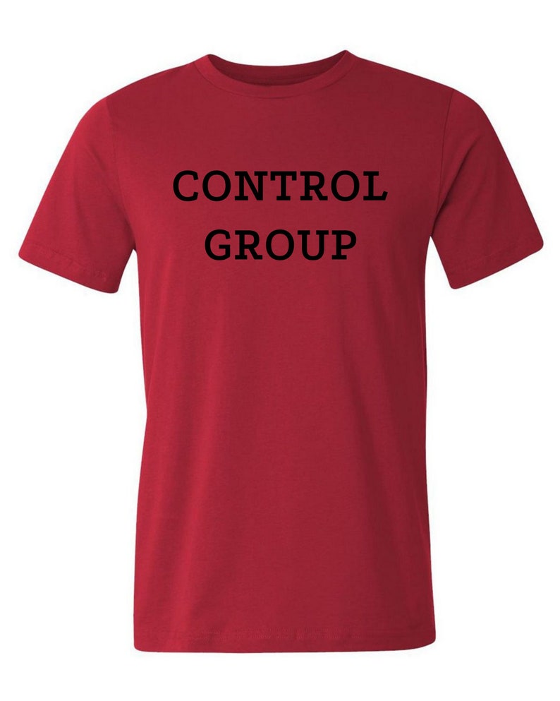 May include: Red t-shirt with the text "CONTROL GROUP" printed in black.
