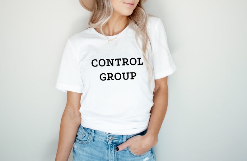 May include: White t-shirt with black text that reads "CONTROL GROUP".