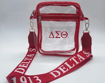 Delta Sigma Theta adjustable purse strap and clear purse.