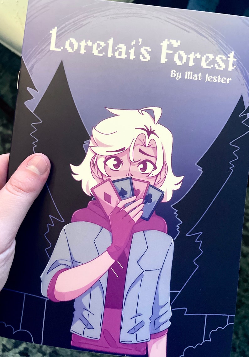May include: A comic book cover with a purple and black background featuring a character with white hair holding playing cards in front of their face. The title of the comic is "Lorelai's Forest" by "Mat Jester".