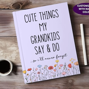 May include: A lavender journal with the text "Cute Things My Grandkids Say & Do...so I'll never forget" in black. The journal is decorated with a border of colorful flowers.
