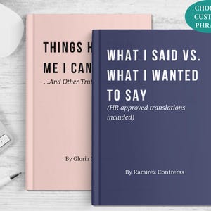 May include: Two hardcover books, one blush pink and one navy blue, are displayed. The pink book reads "THINGS H ME I CAN...And Other Truths" and the blue book reads "WHAT I SAID VS. WHAT I WANTED TO SAY (HR approved translations included)". A white pen and keyboard are also visible.
