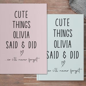 May include: Two pink and blue journals with the text "Cute Things Olivia Said & Did...so I'll never forget" on the front.