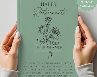 May include: A sage green journal with the words "Happy Retirement" and "Stephanie" in elegant script. The cover features a floral design of three roses. The text "Multiple Design Options Available" is in the upper right corner.