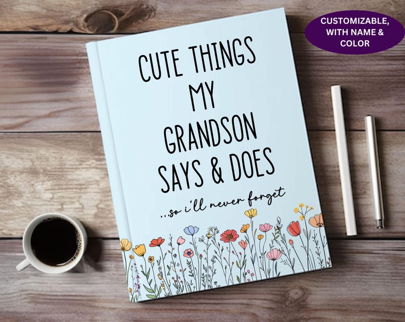 May include: A light blue journal with the text "Cute Things My Grandson Says & Does...so I'll never forget" in black. The journal is decorated with a border of colorful flowers.