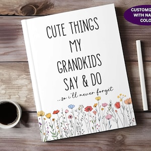 May include: A white journal with the text "Cute Things My Grandkids Say & Do...so I'll never forget" and a border of colorful flowers. The journal is customizable with a name and color.