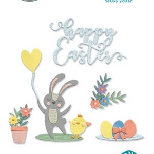May include: A die-cut set featuring Easter-themed designs. Includes a bunny holding a yellow heart balloon, a chick, flowers, and eggs. The words "happy Easter" are also included. The set is from Lisa Jones and Sizzix.