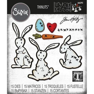 May include: A set of 15 metal dies for crafting featuring a bunny rabbit, carrot, heart, and egg. The dies are designed with a stitched look and are part of the Jim Holtz collection.