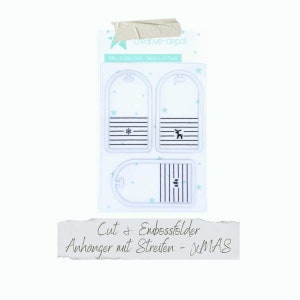May include: A set of four white plastic cut and embossing folders for creating Christmas gift tags. The folders feature a snowflake, reindeer, and striped designs. The text on the packaging reads "Cut & Embossfelder Anhänger mit Streifen - XMAS".