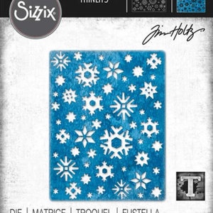 May include: A blue die-cut stencil featuring a repeating pattern of snowflakes and stars. The stencil is designed by Jim Holtz and is part of the Sizzix Thinlits line. The product number is 664967. The text "DIE | MATRICE | TROQUEL | FUSTELLA ВЫРУБКА | STANZE | CORTANTE" is printed at the bottom of the image.