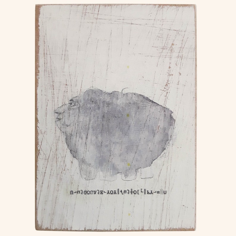 May include: A gray and white abstract painting of a creature with a text inscription at the bottom that reads "U-LA-H-T-O-X-A-E-V-U-G-N-I-H".