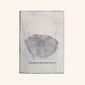 May include: A white wooden sign with a gray watercolor painting of a sheep. The text "u-la-x-a-t-o-r-o-c-o-o-m-n" is printed below the sheep.