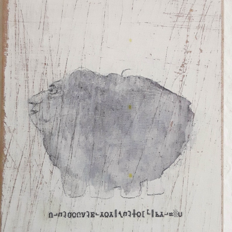May include: A gray abstract painting with a white background. The painting features a gray, blob-like shape with a face and a few yellow dots. The text "U-LA-201-XOX-3-000000-U" is written at the bottom of the painting.