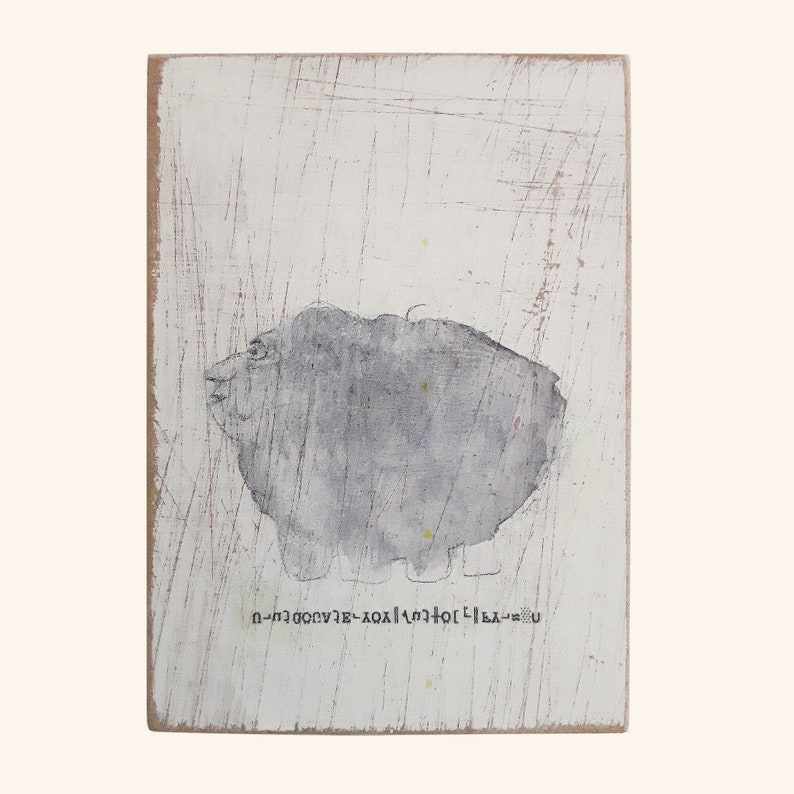 May include: A white wooden sign with a gray abstract shape and the text "U + L + 1 + 0 + X + 2 + 0 + 0 + V + E + 3 + H + - +"
