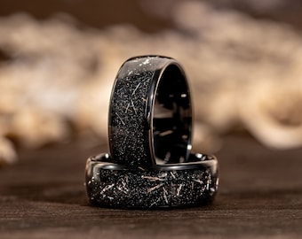 May include: Two black rings with a silver sparkle finish. The rings are stacked on top of each other.