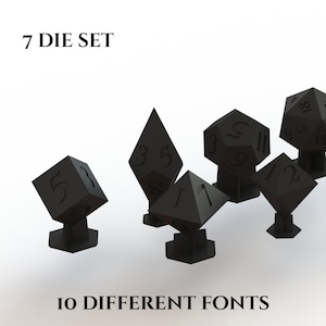 May include: A set of seven black dice with different numbers and fonts. The dice are on small black stands. The text "7 DIE SET" and "10 DIFFERENT FONTS" is visible in the image.