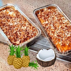 May include: Two rectangular aluminum foil pans filled with a baked dessert, topped with shredded coconut. Three pineapples and a coconut half are in the foreground. The dessert has a golden-brown color.