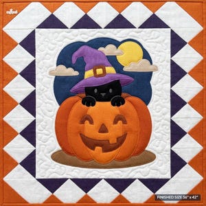 May include: A square fabric quilt featuring a black cat wearing a purple witch hat inside an orange jack-o'-lantern. The background is dark blue with a yellow moon and beige clouds. The border has orange, white, and dark purple triangles. Size 36" x 42".