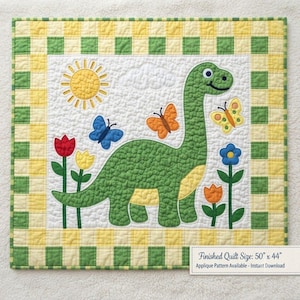 May include: A quilted wall hanging featuring a green dinosaur, a yellow sun, butterflies, and flowers on a white background with a yellow and green checkered border. The text on the image states: Finished Quilt Size: 50" x 44". Applique Pattern Available - Instant Download.