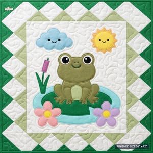 May include: A square quilt featuring a central green frog sitting on a lily pad with a pink cattail, a light blue cloud, and a yellow sun. The border consists of white and light green triangles with a dark green edge. Finished size 36" x 42".