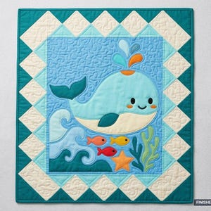 May include: A rectangular quilt featuring a central light blue panel with a cartoon whale, orange and yellow fish, a starfish, and green seaweed. The border consists of cream and teal triangles. The finished size is 91.44 cm by 106.68 cm.
