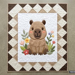 May include: A rectangular quilt featuring a central appliqué of a brown capybara surrounded by colourful flowers on a white background with swirl quilting. The border consists of alternating white and tan triangles. Finished size 91.44 cm x 106.68 cm.