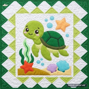 May include: A square quilt featuring a green sea turtle appliqué, a bright orange starfish, light blue bubbles, and colorful seashells on a white background. The border consists of green and white triangles. Finished size 36 inches x 42 inches.