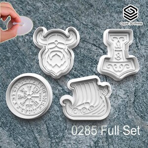 May include: A collection of four white plastic cookie cutters featuring Viking designs. The set includes a Viking face, a hammer, a compass, and a Viking ship. The text "0285 Full Set" is printed at the bottom of the image.