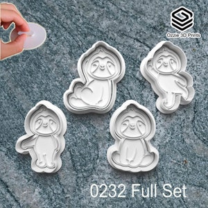 May include: A collection of four white plastic sloth-shaped cookie cutters. The cutters depict sloths in various poses. The text "0232 Full Set" is at the bottom. The Ozzie 3D Prints logo is in the top right corner.