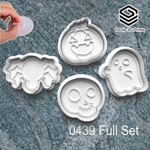 May include: A collection of white Halloween cookie cutters featuring a pumpkin, ghost, spider, and skull design. The text "0439 Full Set" is printed below. The Ozzie 3D Prints logo is visible. Ideal for baking spooky treats.