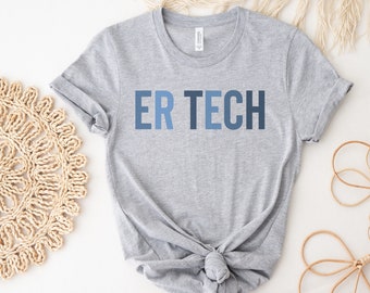 May include: A light gray t-shirt with the text "ER TECH" in shades of blue. The shirt is knotted at the waist. The sleeves are rolled up. The shirt is made of a soft material.