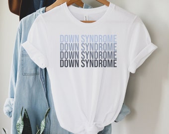 May include: White t-shirt with the text "Down Syndrome" repeated four times in a gradient of blue.