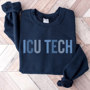 May include: A navy blue sweatshirt with the text "ICU TECH" printed in a gradient of blue shades.