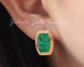 May include: A gold-toned stud earring with a rectangular, green jade center stone. Small pink gemstones are set on either side of the jade. The earring is set against the backdrop of a person's ear. The text "Jadeite Jade Jewelry" is visible.