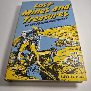 May include: A vintage book titled "Lost Mines and Treasures of the Pacific Northwest" with a blue cover. The cover illustration depicts two figures searching for treasure. The author's name, Ruby El Hult, is visible.