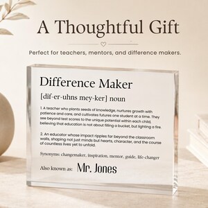 May include: A clear acrylic block with the words "Difference Maker" and its definition. The text includes synonyms like changemaker and inspiration. The phrase "A Thoughtful Gift" is at the top.