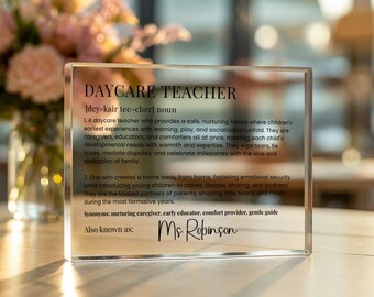 May include: A clear acrylic block featuring the words "DAYCARE TEACHER" and a definition of the role. The block is personalised with the name "Ms. Robinson". The text describes the role of a daycare teacher.