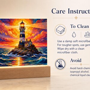 K&ouml;nnte beinhalten: Ein quadratischer Acryl-Leuchtkasten mit einer farbenfrohen Leuchtturmszene bei Sonnenuntergang auf einem rechteckigen Holzsockel. Der Text lautet Care Instructions, To Clean, Use a damp soft microfiber cloth. For tougher spots, use gentle soap. Wipe dry with a clean microfiber cloth. Avoid, Avoid harsh chemicals, isopropyl alcohol, and chemical liquid cleaners.