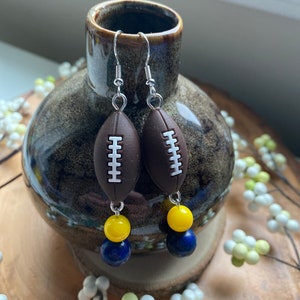 Maize and blue glass bead and football earrings