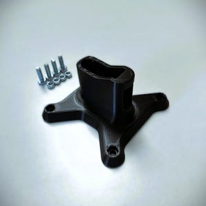 May include: A black plastic 3D printed base with a square opening on top. The base has four arms extending out from the centre. There are five silver screws and nuts on a white surface.
